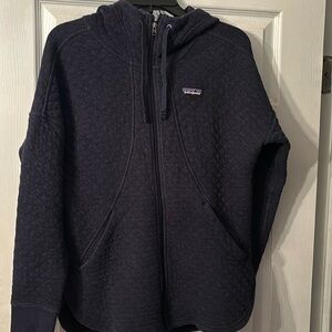 Small Navy blue Patagonia zip up hooded jacket.